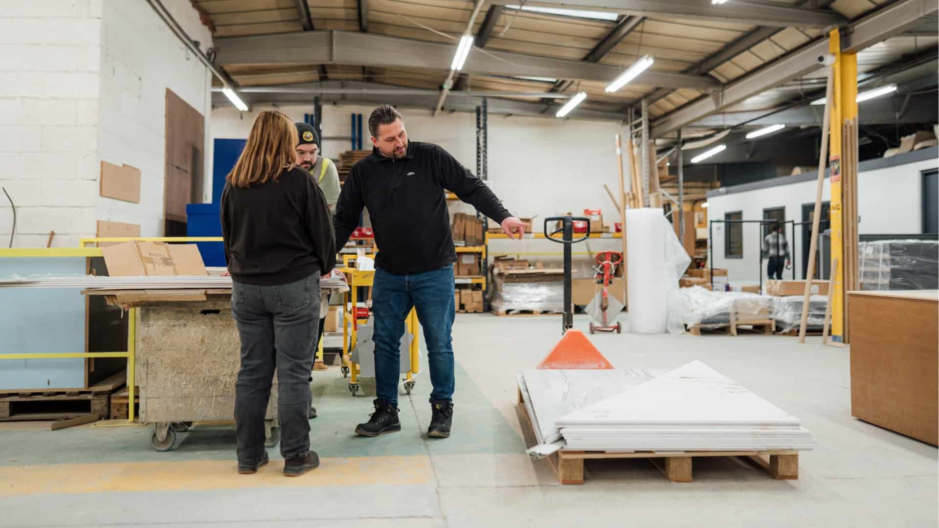 Custom furniture being discussed in a manufacturing facility.